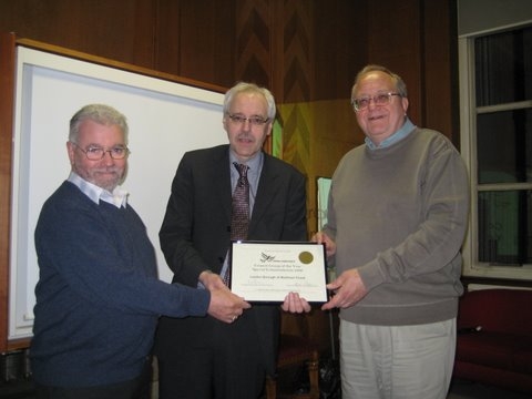 Lib Dem local government leader Cllr Richard Kemp presents  councillors Bob Belam and Bob Sullivan with the Council Group of the year awards certificate.